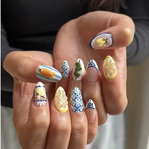 Detail of 3D lemon and blue porcelain patterns on almond shaped press-on nails