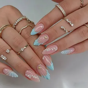 Macro detail of blue French tips with 3D shell texture and pearl nail art charms