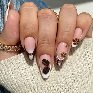 Macro shot of coffee bean 3D nail art designs on glossy almond shaped nails