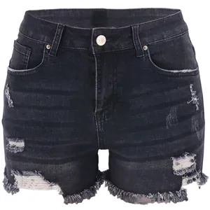 Detailed view of charcoal black distressed denim shorts with ripped holes and raw hems
