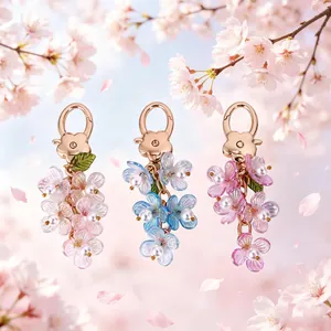 Colorful luminous cherry blossom keychains with pearl accents in three vibrant color sets