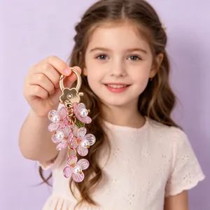 Luminous pink flower keychain with white pearls and golden floral metal clasp