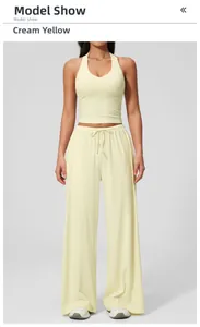 Front view of creamy yellow yoga set featuring V-neck tank top and drawstring trousers