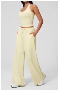 Detail view of the soft yellow ribbed fabric texture on yoga crop top and drawstring pants