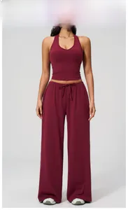 Detail of cherry red yoga set featuring halter neck top and drawstring wide-leg pants