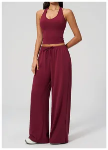 Detail view of burgundy yoga set featuring halter neck top and drawstring wide leg pants
