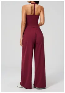 Detail of burgundy backless halter top and high-waist wide-leg yoga pants set