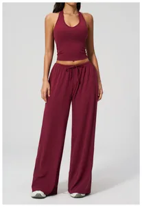 Detail of wine red halter neck crop top and high waist wide-leg yoga trousers set