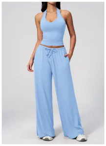 Detail shot of light blue yoga set with halter crop top and drawstring wide leg pants