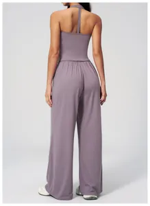 Detail view of the moisture-wicking racerback top and wide-leg yoga pants set in mauve