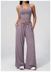 Detail of mauve halter-neck yoga set featuring drawstring waist and wide-leg trousers