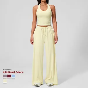 Two-piece yoga set with yellow halter neck tank top and wide-leg drawstring pants