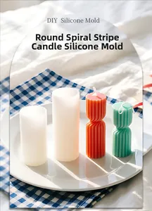 Close-up of DIY silicone mold and finished spiral striped pillar candles in home setting