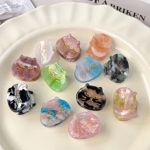 Colorful mini cat-shaped acetate hair claws with elegant marble texture and gold detailing