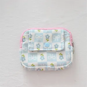 Detail of floral corduroy mini pouch showing the front pocket with blue snap button