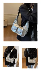 Detail view of metallic silver y2k shoulder bag featuring dual functional pockets