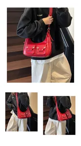 Close-up of bright red hobo bag with silver studs and adjustable shoulder strap detail