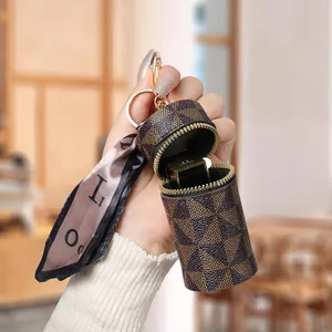 Mini astuccio per rossetto con motivo a scacchi, zip in metallo e ciondolo con nastro