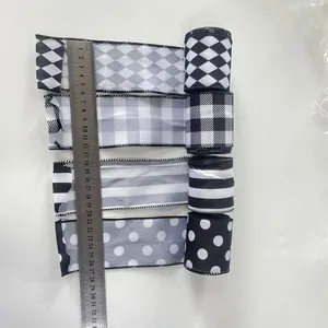 Detailed view of 6cm black and white striped ribbon rolls with refined edge stitching