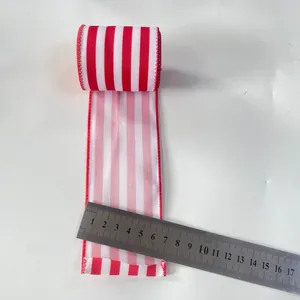 Macro detail of 6.3cm red and white striped ribbon with stitched edges for Xmas