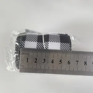 6cm wide checkerboard pattern fabric ribbon roll measured with a stainless steel ruler