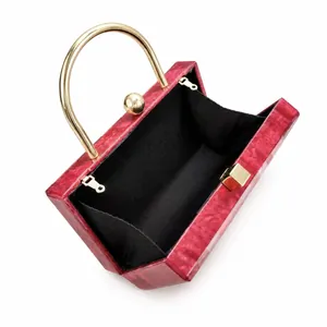 Red marble acrylic evening clutch bag with gold handle and black fabric lining