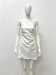 Detailed view of white strapless lace dress with floral embroidery and side pleats