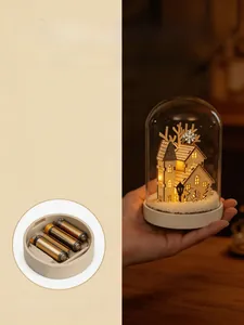 Detail of battery compartment on a warm LED wooden Christmas house in a glass dome