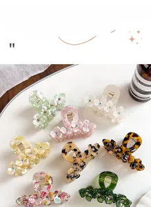 Detailed macro view of acetate floral claw clips with sparkling center diamond accents