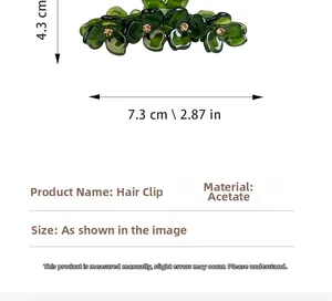 Detail view of a 7.3cm dark green acetate flower hair claw clip with rhinestone accents