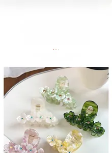 Detail of floral acetate hair claws with rhinestones in multiple assorted colors
