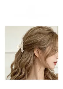 Detail of cream flower hair claw clip with sparkling rhinestones for women
