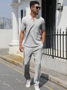 Close-up of men's grey zippered polo and pants set with textured fabric texture