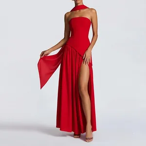 Detail of red floor-length gown featuring high slit and matching neck scarf accessory