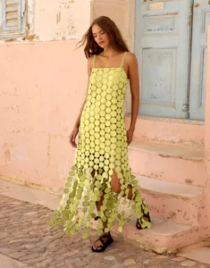 Close-up of lime green sundress with unique 3D circular cut-outs and lace details