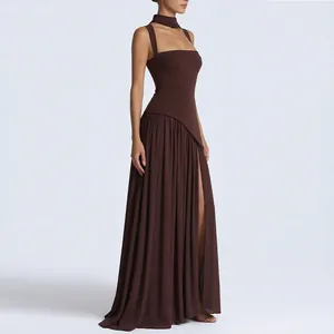 Detail view of chocolate brown halter neck maxi dress with side slit and pleated skirt