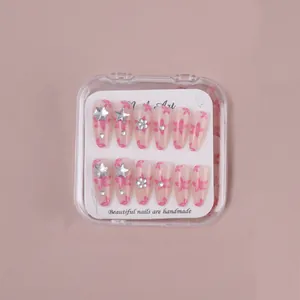 Detail of pink almond nails with 3D silver flower charms and rhinestone accents