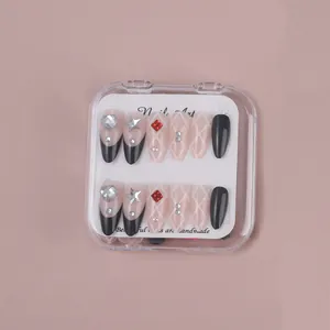 Detail view of almond press-on nails with glitter diamonds and pink french design
