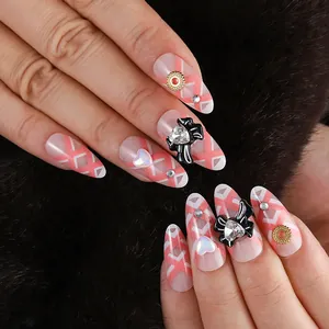 Detail of almond-shaped nails with pink-white geometric lines and 3D bow jewelry