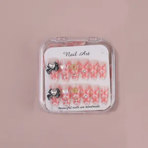 Pink gradient almond press-on nails with 3D bows, rhinestones and heart charms