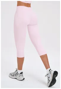 Close-up of high-waisted pink capri yoga leggings showing tight fit and brushed fabric