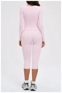 Rear view of pink long sleeve athletic top and cropped high waist yoga leggings