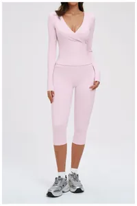 Detail showing the light pink high-waist yoga shorts with brushed elastic fabric texture
