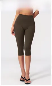 Detail view of high-waisted dark coffee yoga leggings with seamless athletic fabric