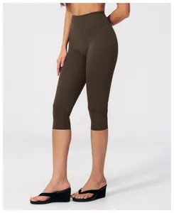 Detail view of high-waist yoga capri leggings in dark brown with brushed texture