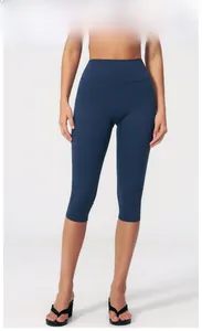 Detail view of high waist yoga capris in Badge Blue showing elastic sports fabric