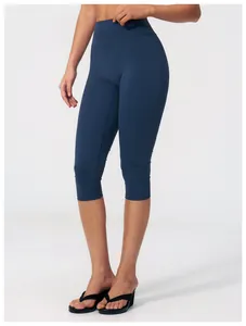 Detail of high-waist dark blue yoga leggings with elastic compression fabric for women