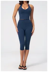 Detail of high-waist navy blue yoga leggings and racerback sports top set for women