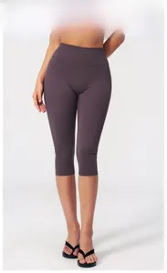 Close-up of eggplant purple high-waisted yoga leggings showing elastic fabric texture