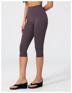 Close-up of high-waist seamless compression yoga capris in dark purple finish